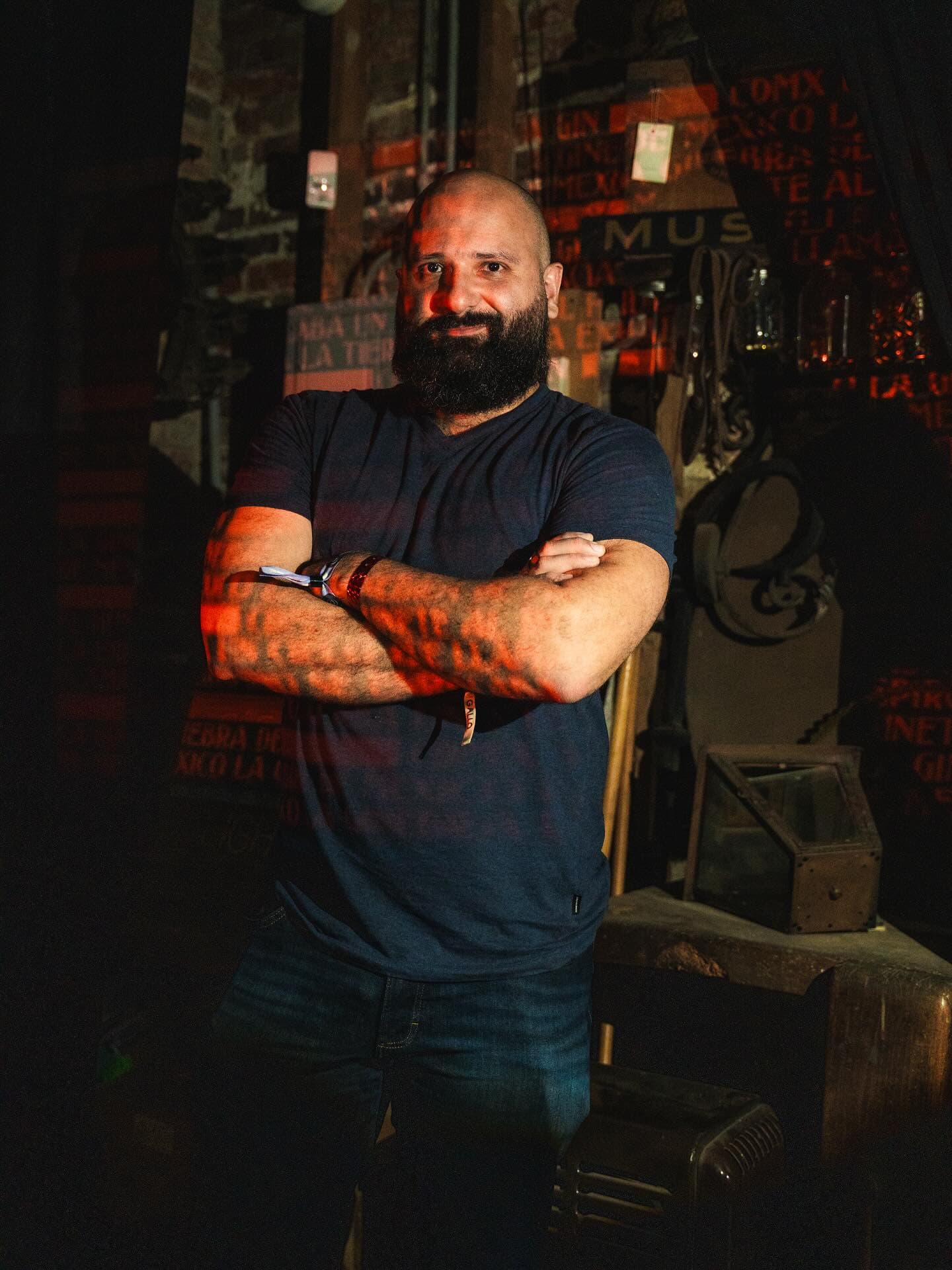 Iván Avilés with arms crossed in a workshop setting in Puerto Rico