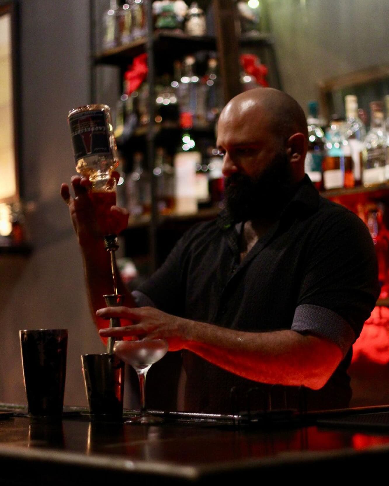 Iván Avilés preparing a cocktail behind a bar in Puerto Rico